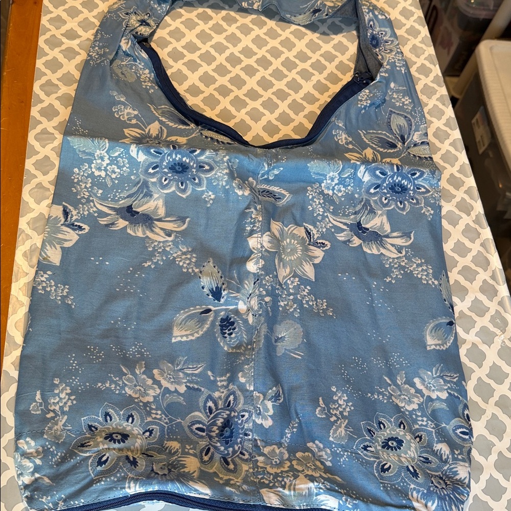 🔹NEW…Avon Reversible Denim Sling …Denim fabric with a white floral pattern.